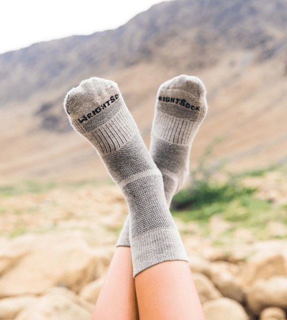 A woman on a trail wearing hiking socks