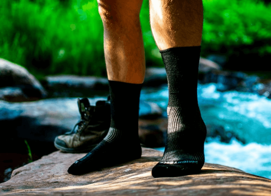 A pair of thick socks on a hiking trail.
